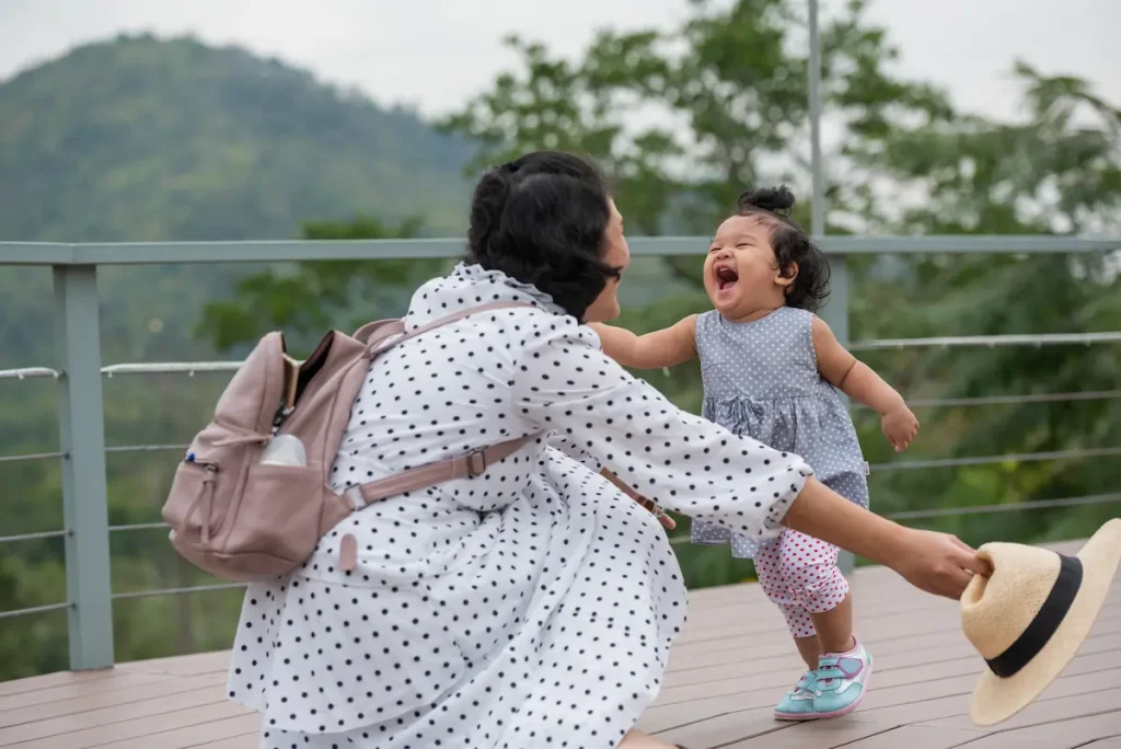 A happy kid running to her mom